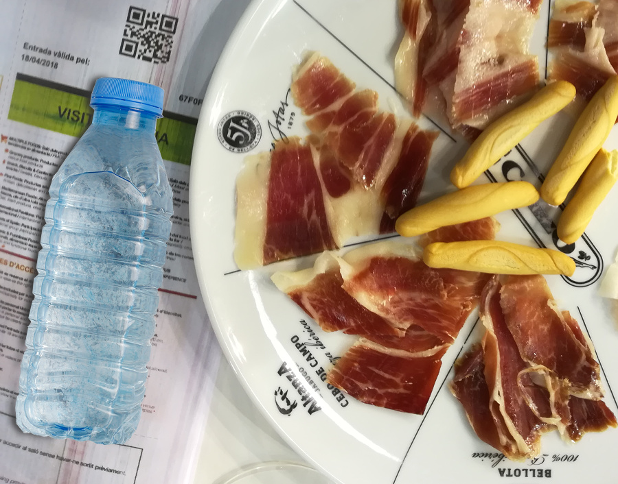 Slices of pata negra ham and a bottle of water